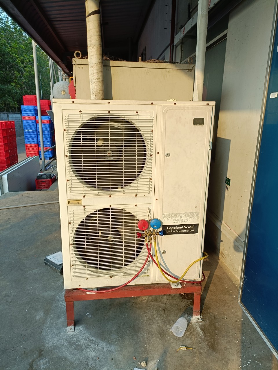 refrigeration technician repairing cold storage unit