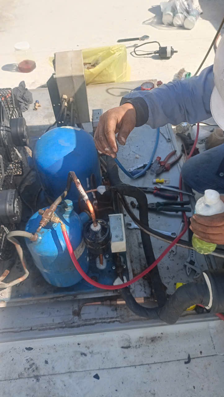 close up of a refrigeration technician checking gas pressure