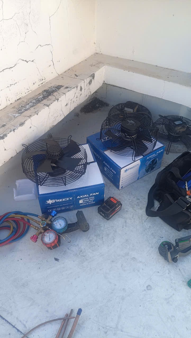 technician using tools to repair refrigeration unit