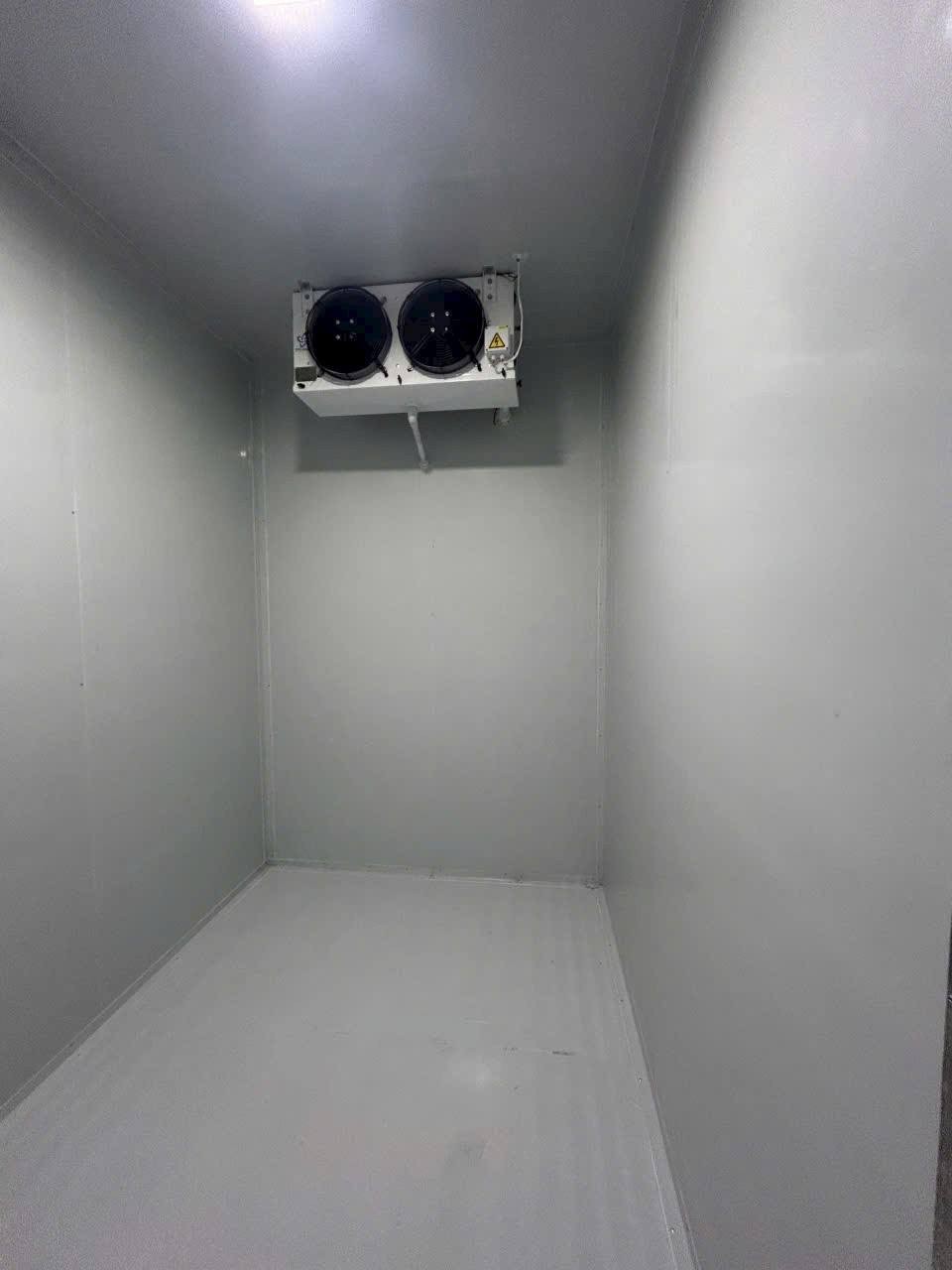 refrigeration technician inspecting a cold storage unit