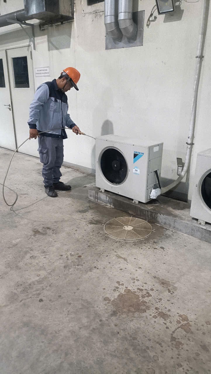 technician repairing air conditioner indoor