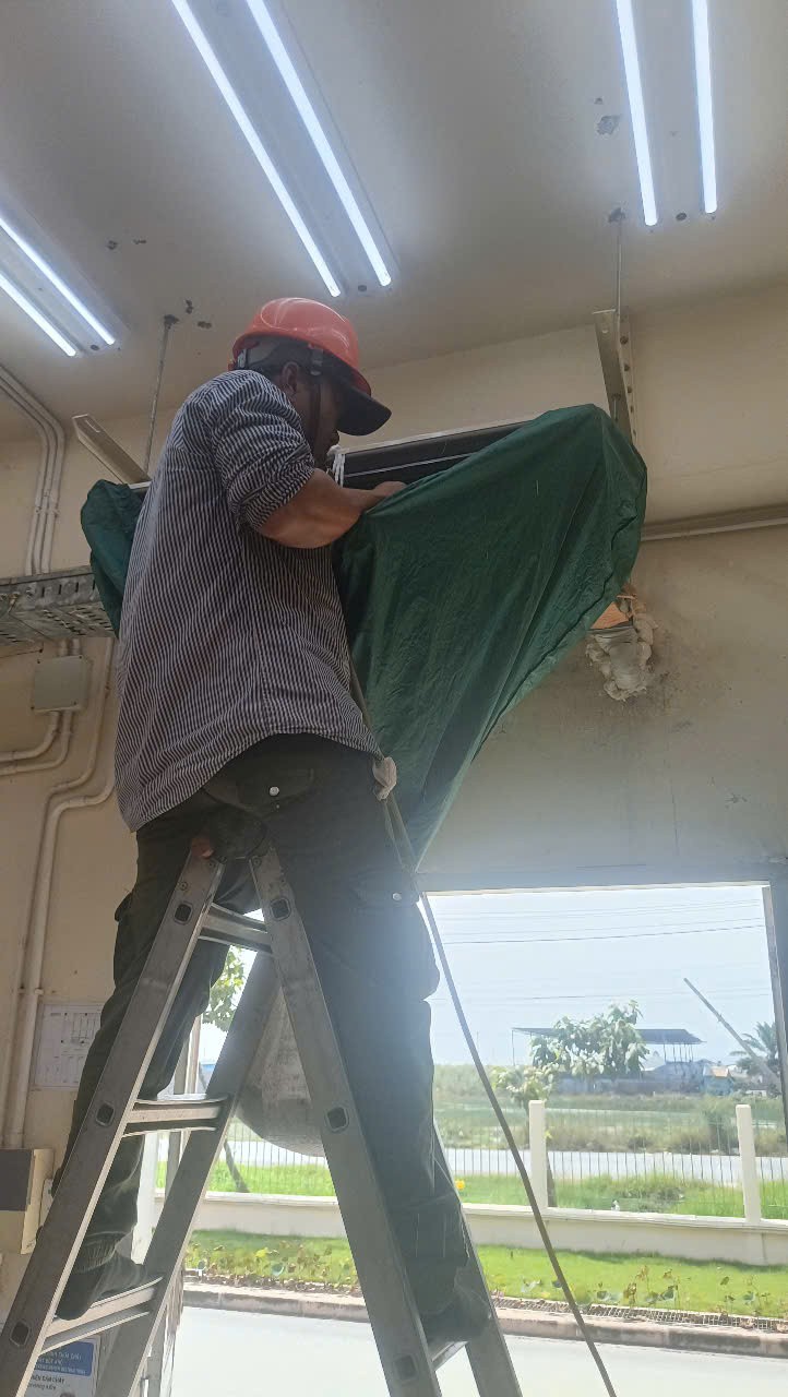technician checking refrigerant levels in air conditioner