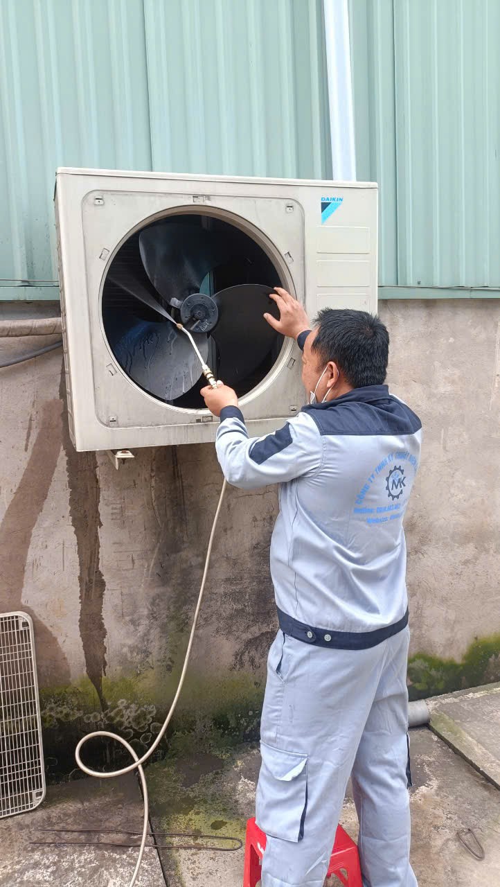 technician repairing air conditioner indoor