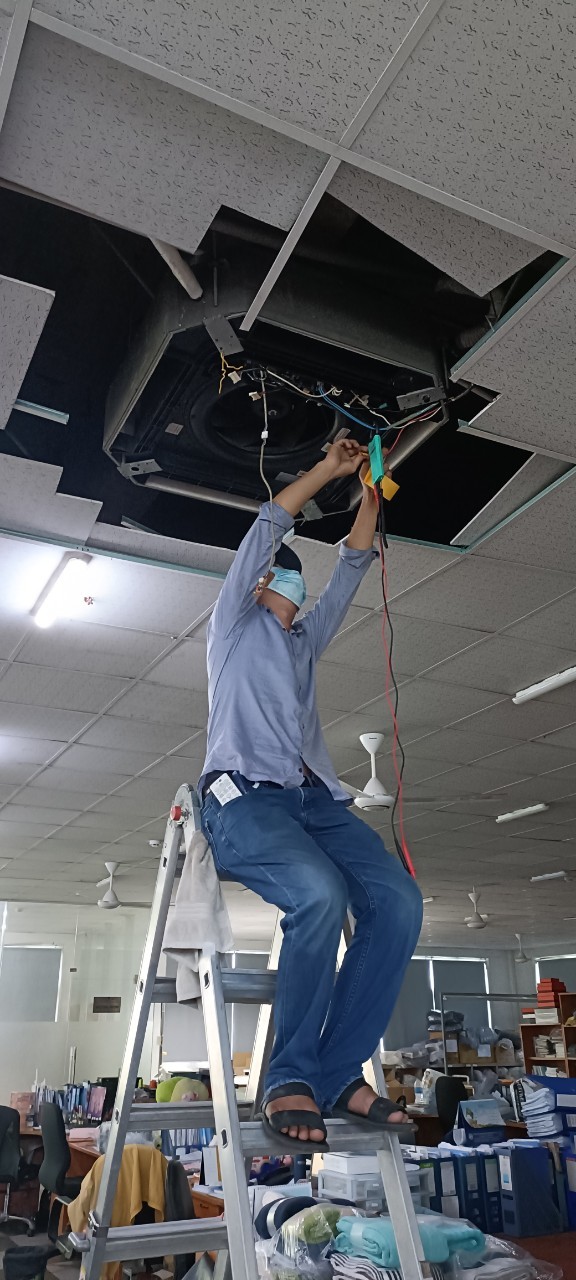 close up of technician repairing air conditioner