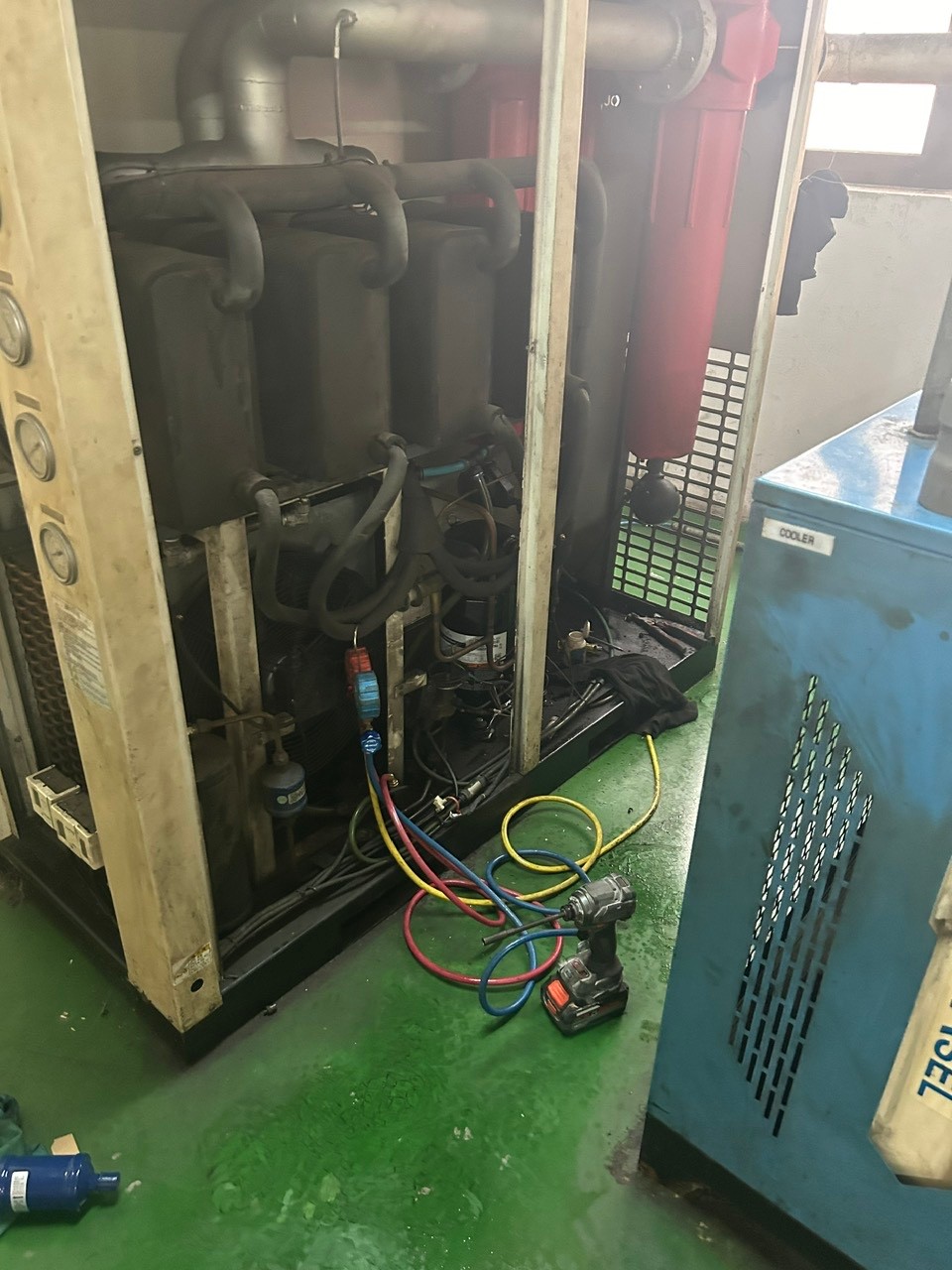 air dryer repair technician inspecting machine