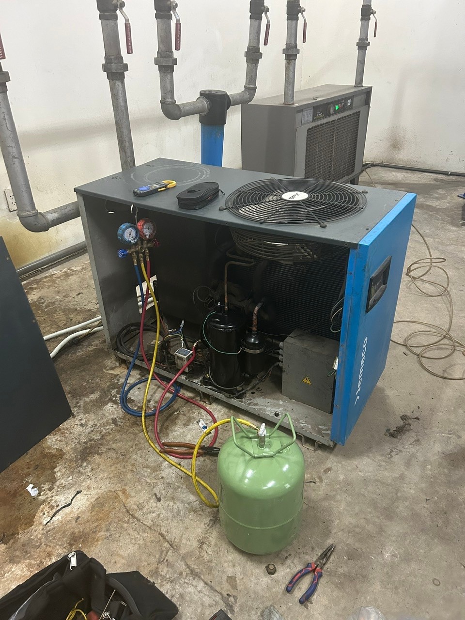technician repairing air dryer