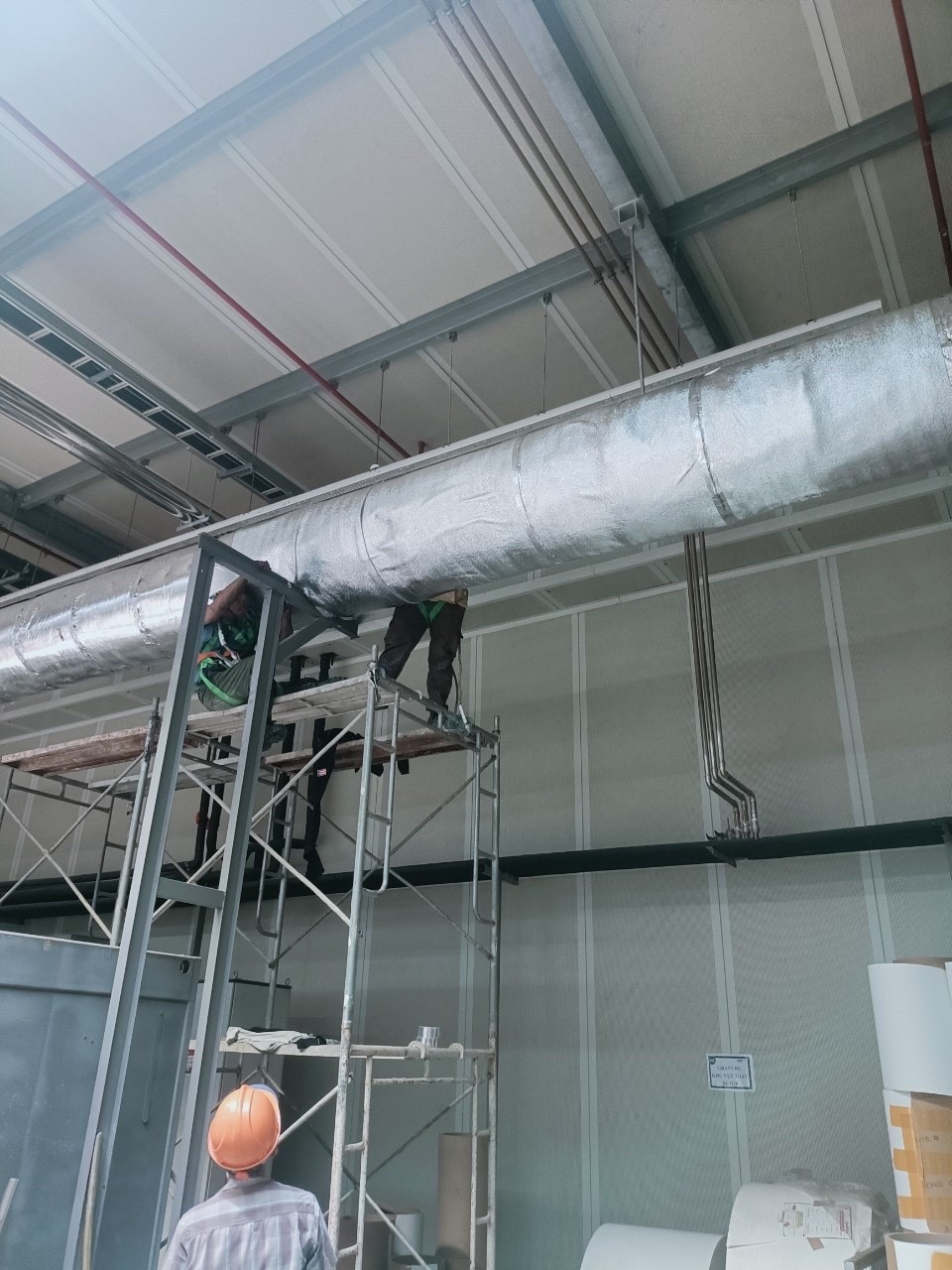 technician installing ventilation duct
