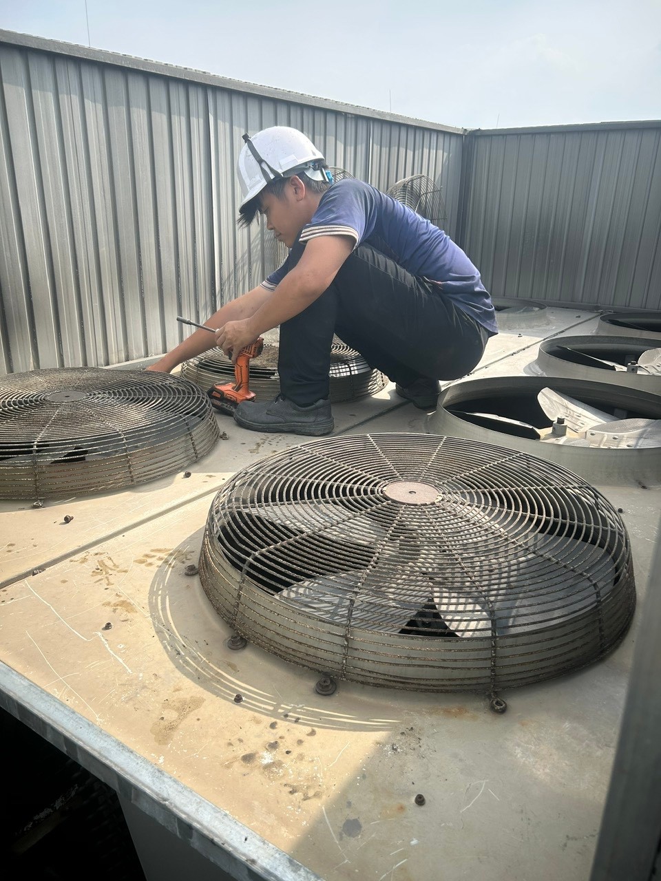 technician repairing industrial air conditioner