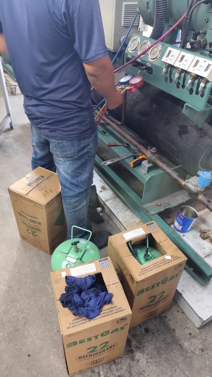 air conditioner repair technician using diagnostic tools