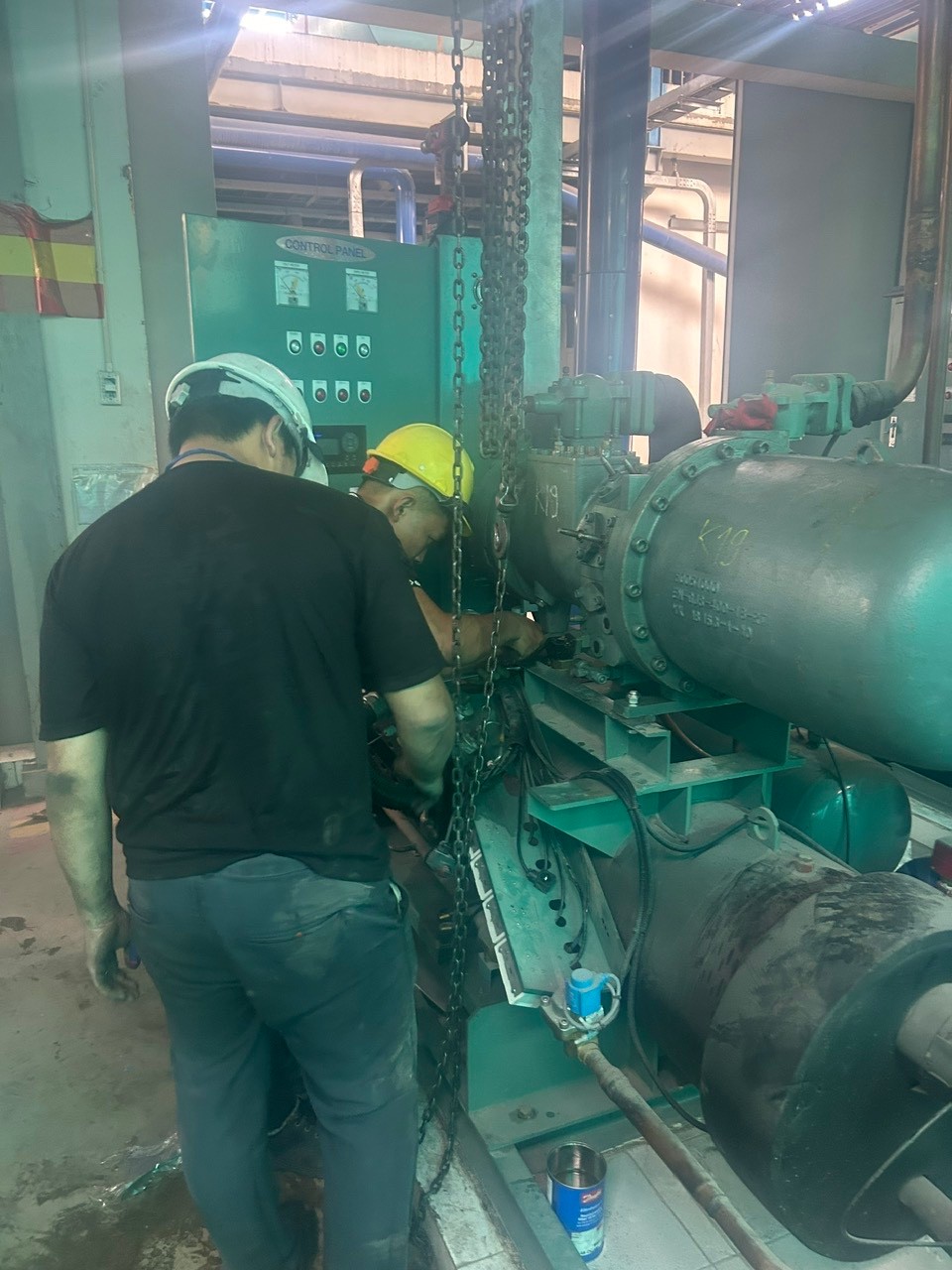 technician checking industrial air conditioner