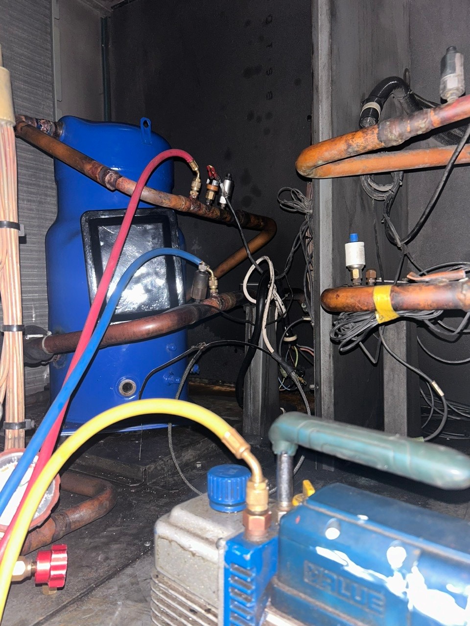 technician repairing industrial air conditioner