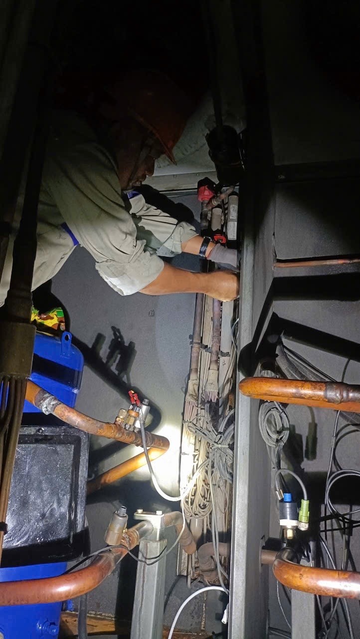 technician repairing chiller unit