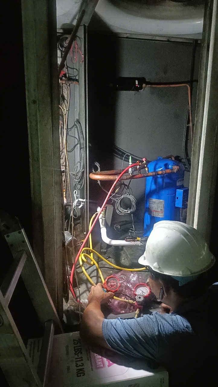 technician using tools to repair chiller