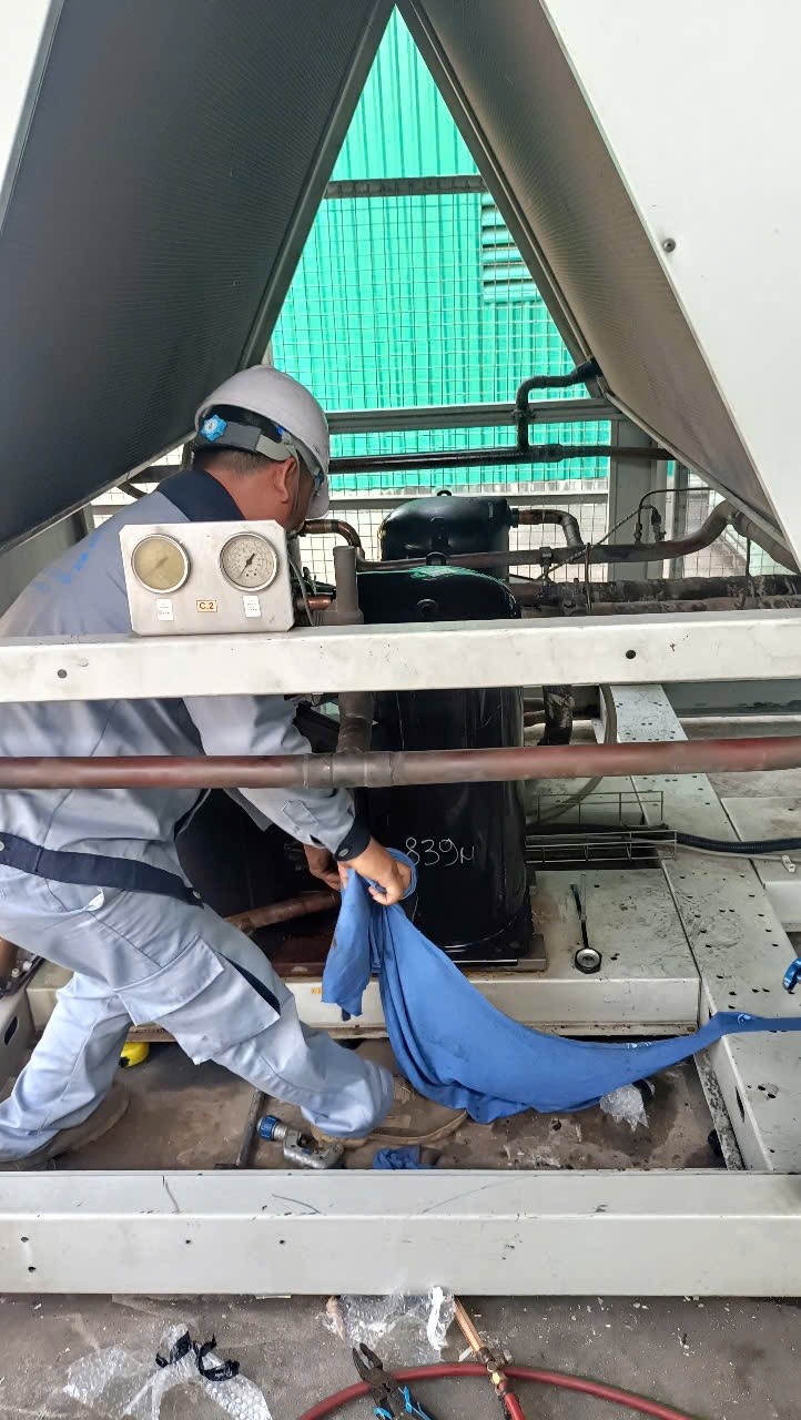 technician repairing chiller unit