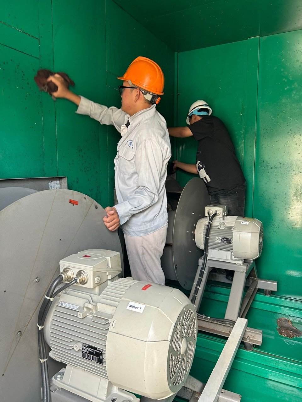 Image of technician cleaning air conditioner coil
