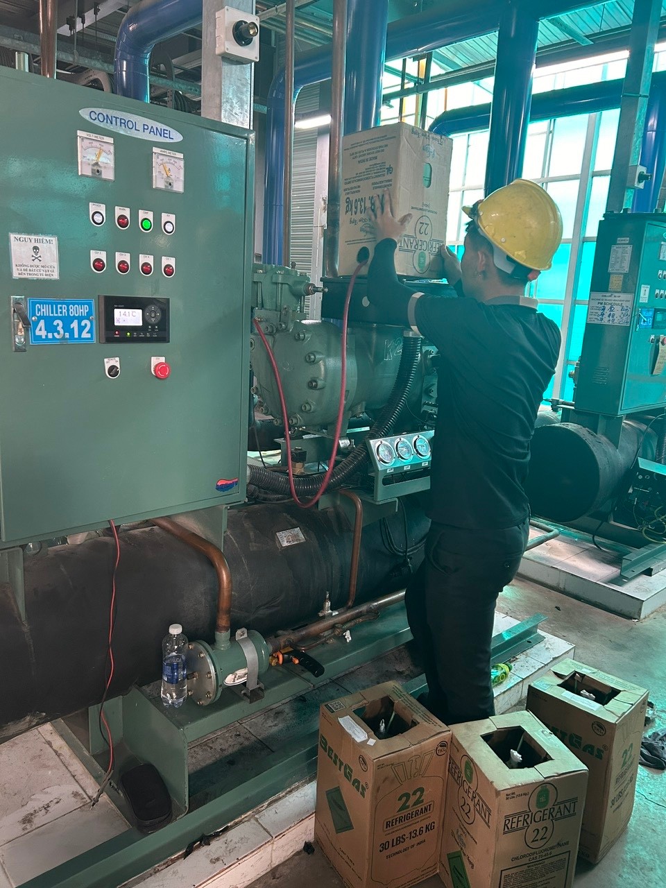 technician cleaning industrial air conditioner