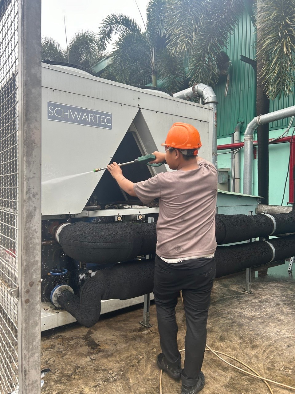 technician cleaning air conditioner
