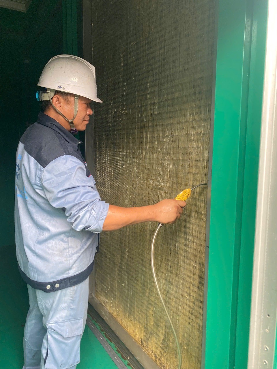 technician cleaning air conditioner coil