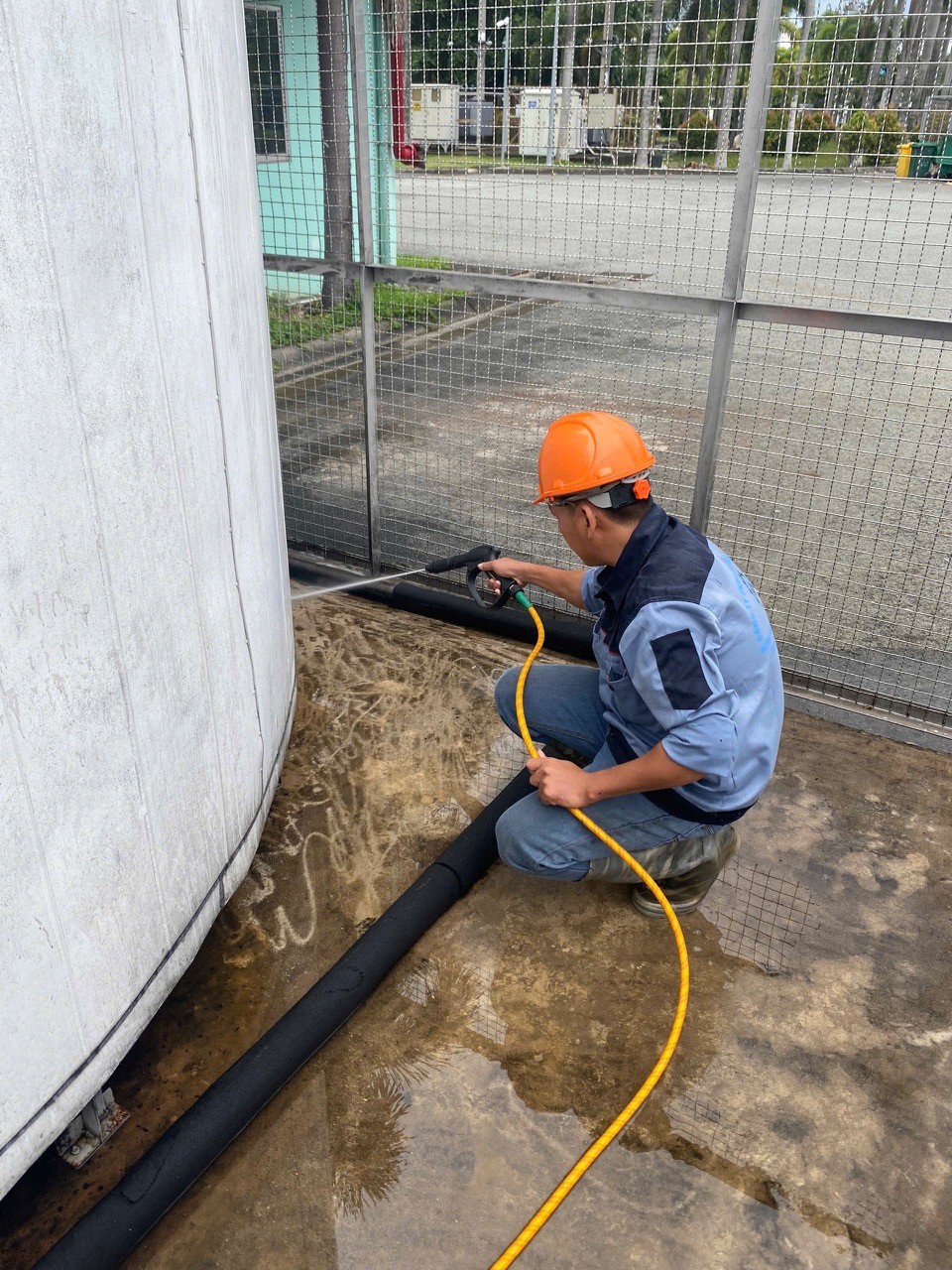 technician cleaning industrial air conditioner