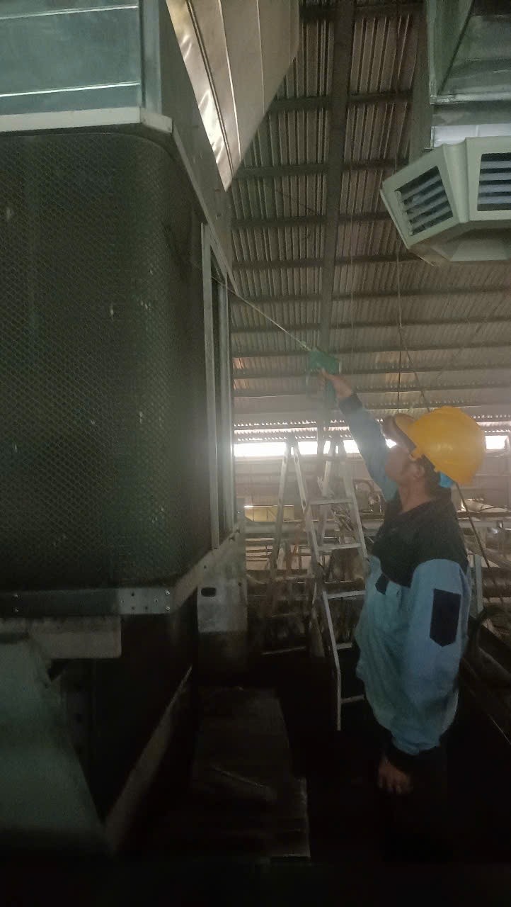 air conditioning maintenance technician cleaning industrial unit