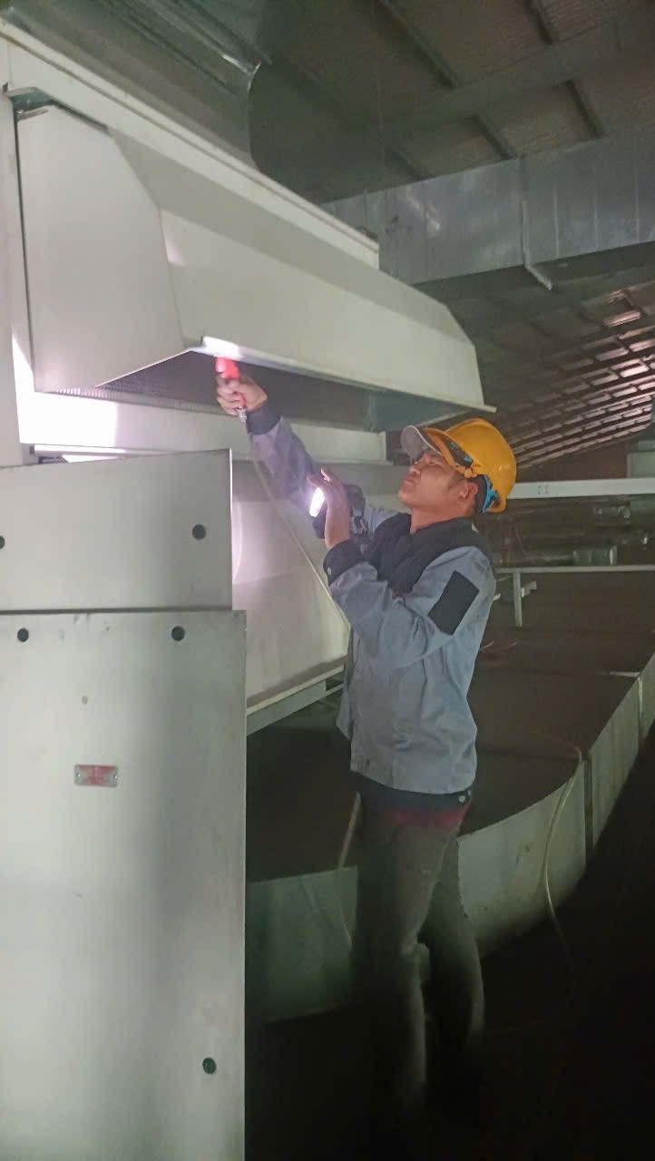technician cleaning industrial air conditioner