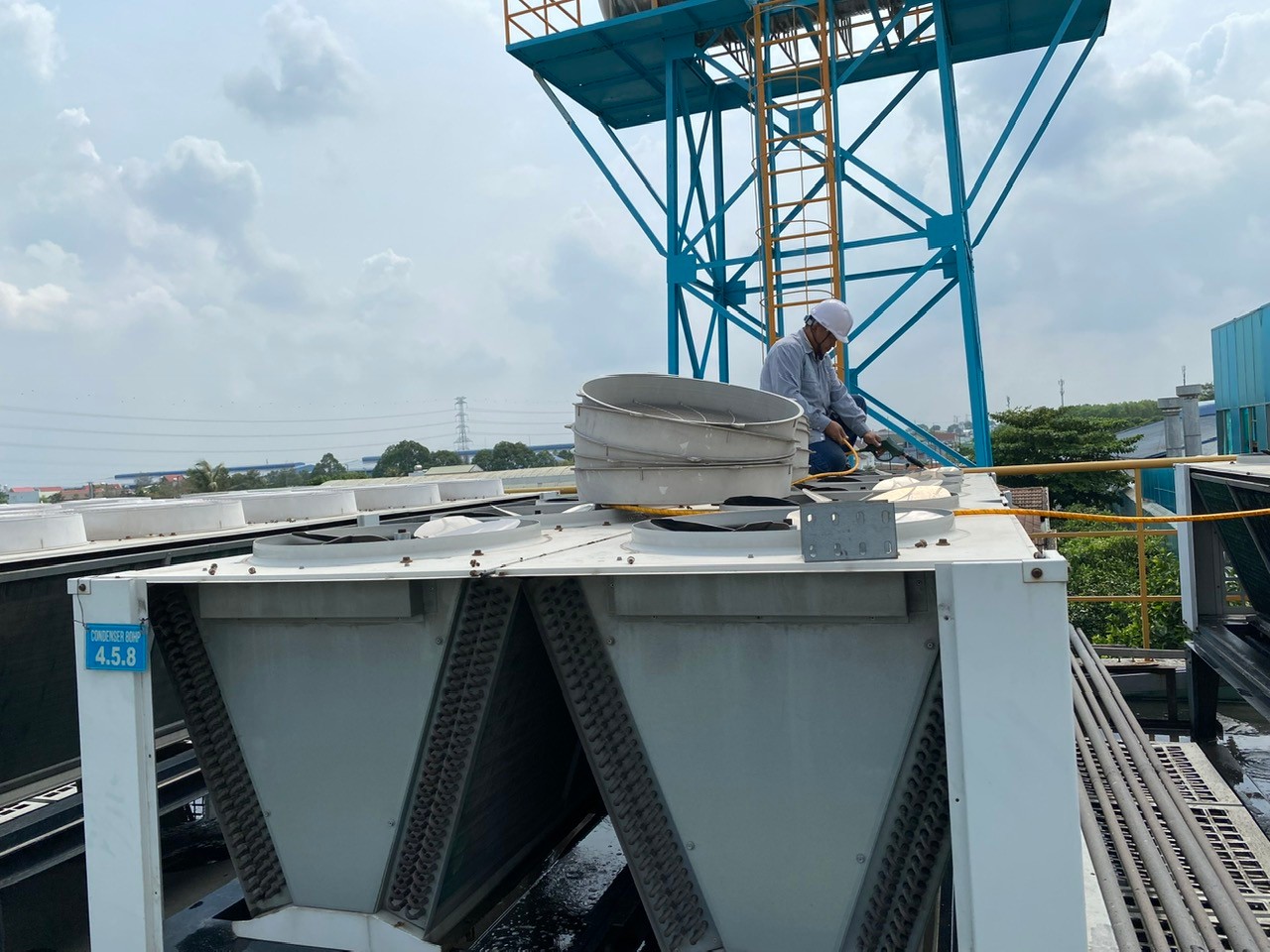 technician cleaning industrial air conditioner